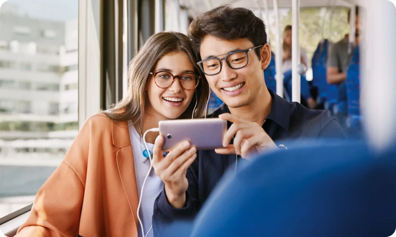 man and woman looking at phone