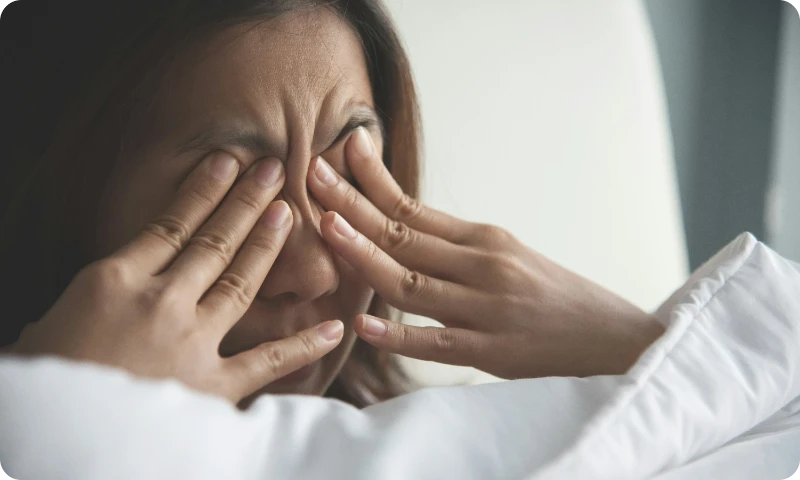 woman scratching eyes